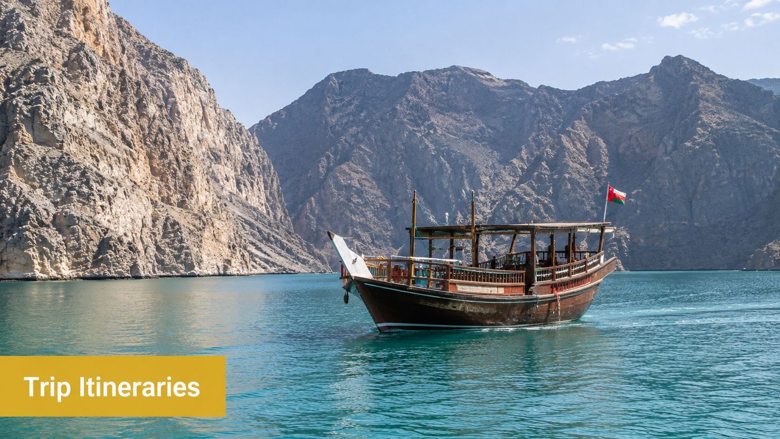 A traditional Omani dhow boat sailing through the stunning turquoise waters of the Musandam fjords.