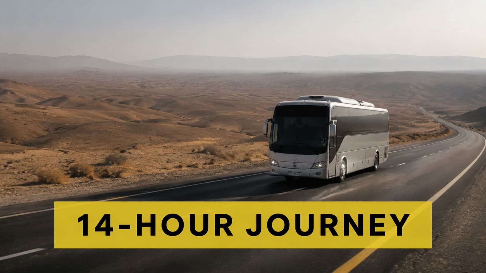 A silver bus traveling along a long, desolate road through a vast desert landscape during a 14-hour journey.