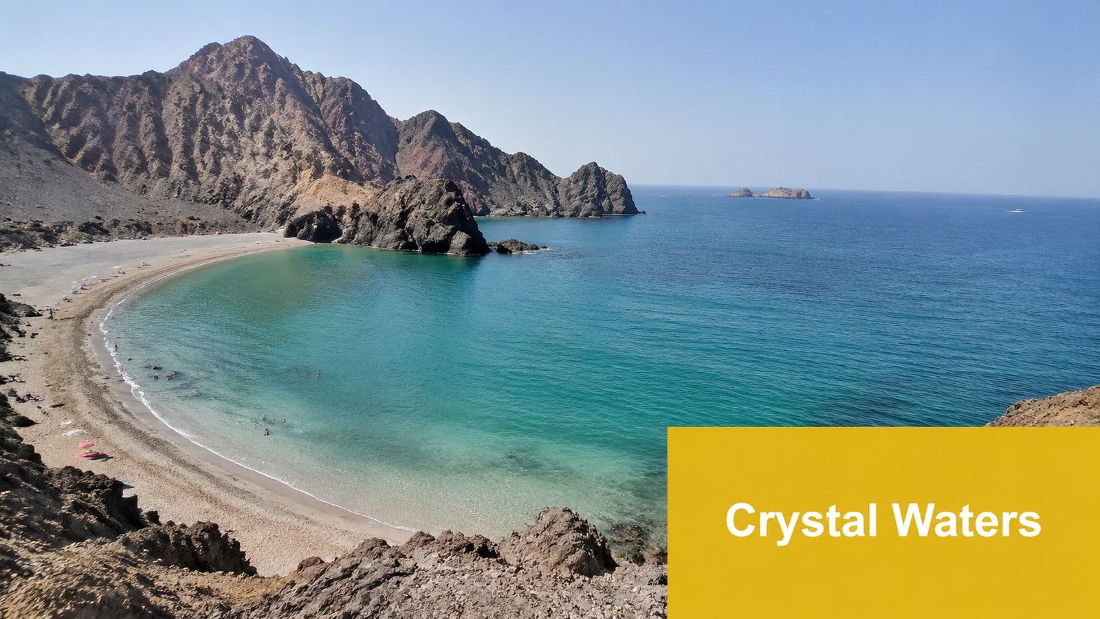 A scenic view of a secluded beach with turquoise crystal waters surrounded by rocky mountain cliffs in Fujairah.