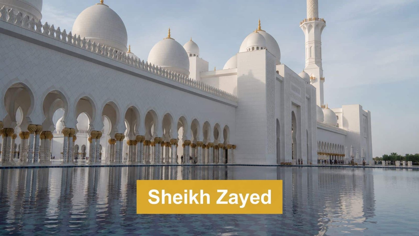 The iconic white marble Sheikh Zayed Grand Mosque reflected in a calm pool of water in Abu Dhabi.