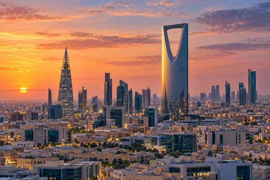 Riyadh skyline at sunset with Kingdom Centre and Al Faisaliah Tower above the city.